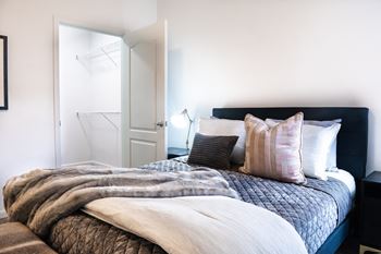 Bedroom with a bed and a nightstand with a lamp